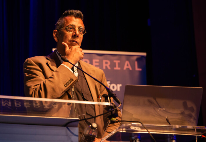 Simon Singh, standing at the podium delivering his lecture.