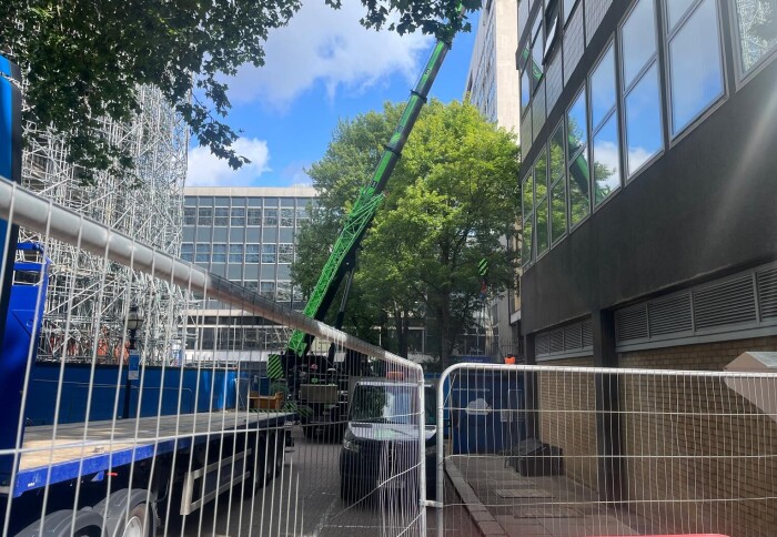 A crane preparing to lift out the last temporary boiler onto the lorry for removal