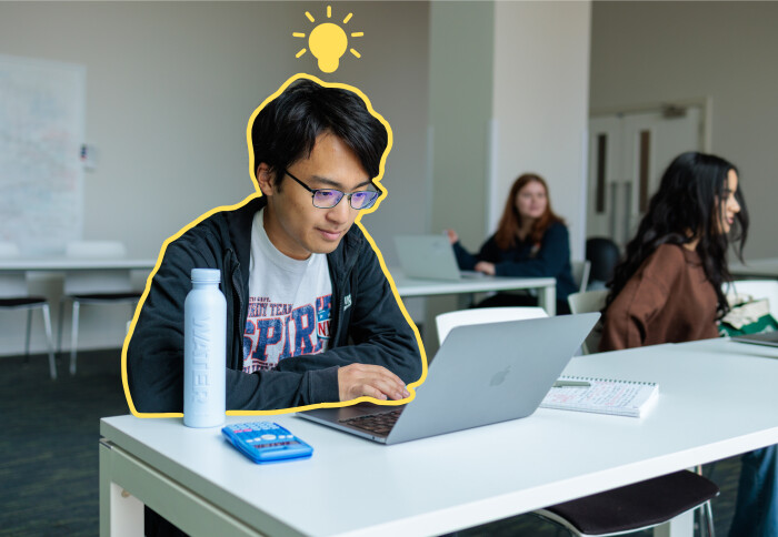 Student sat at a computer, exploring his options, with a lightbulb above his head.