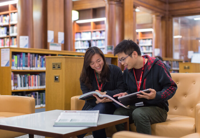 Two students from the School of Public Health work together in the library at St Mary's hospital London