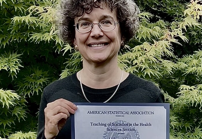 Dr Hilary Watt with her award certificate from the American Statistical Association