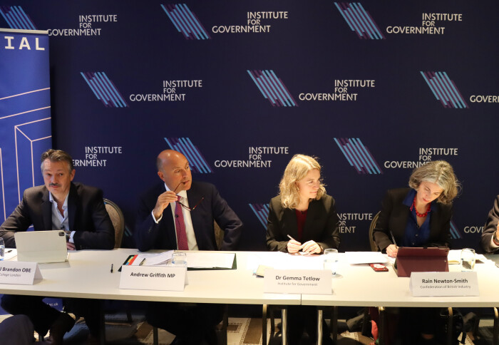 Professor Nigel Brandon, Andrew Griffith MP, Dr Gemma Tetlow and Rain Netwton-Smith sat beside each other at a long table infront of backdrop banners from Imperial and the Institute for Government