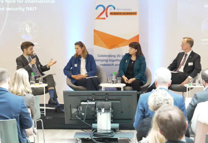 Professor Julie McCann sitting alongside three other people on a stage during discussions in a panel session in front of an audience