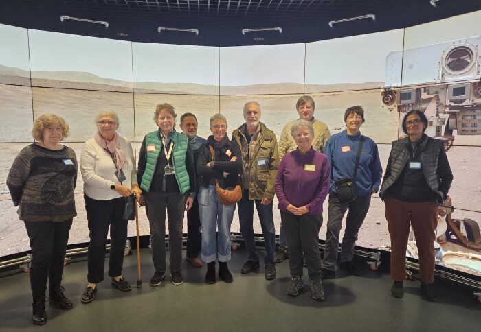 Open Age members stood in front of images of Mars displayed on the DSI screens