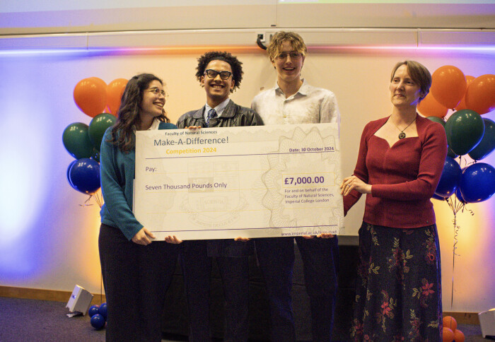 Team Marigold holding up their £7,000 prize for FoNS-MAD 2024