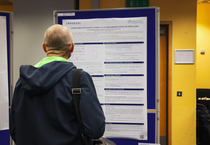 Man looking at research board