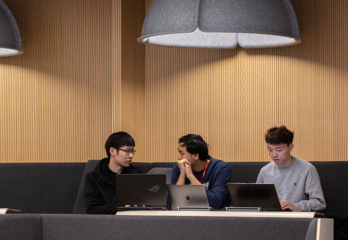 Students with laptops in a lecture theatre.