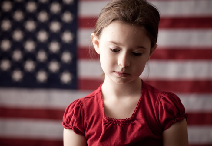 Child in front of US flag