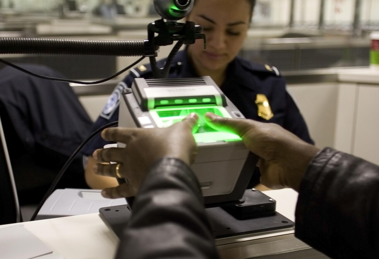 Someone putting their thumbs on a fingerprint reader