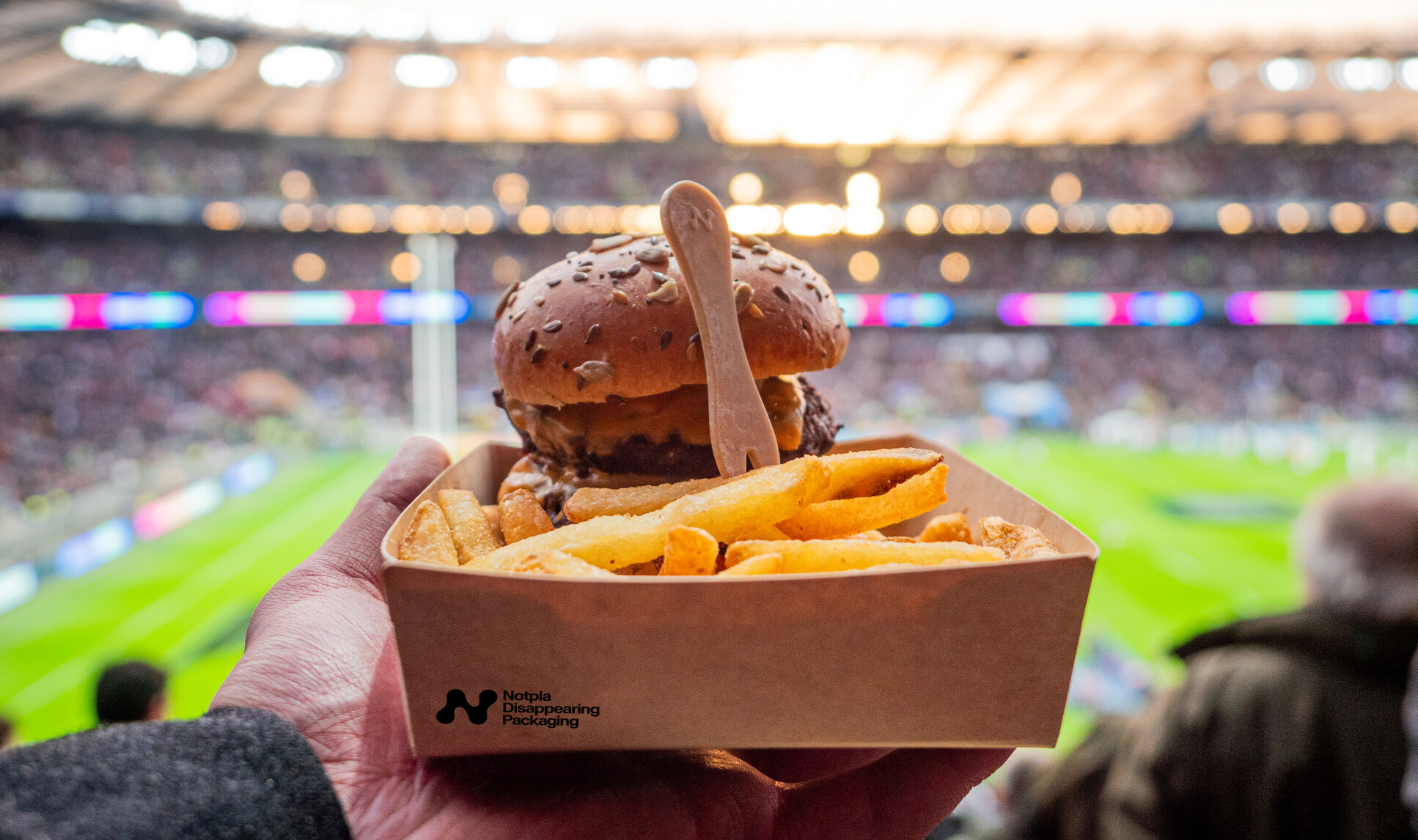 A burger and fries in Notpla packaging