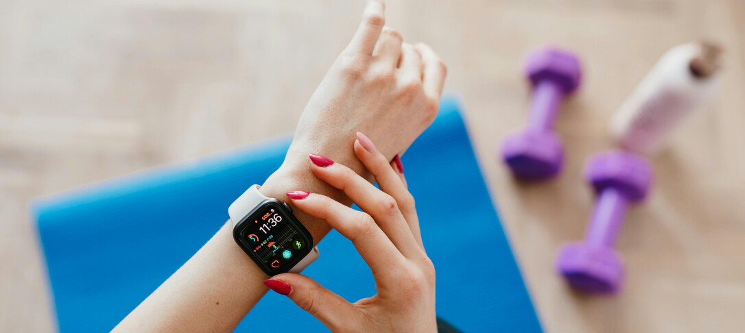 A person checking their smart watch while exercising