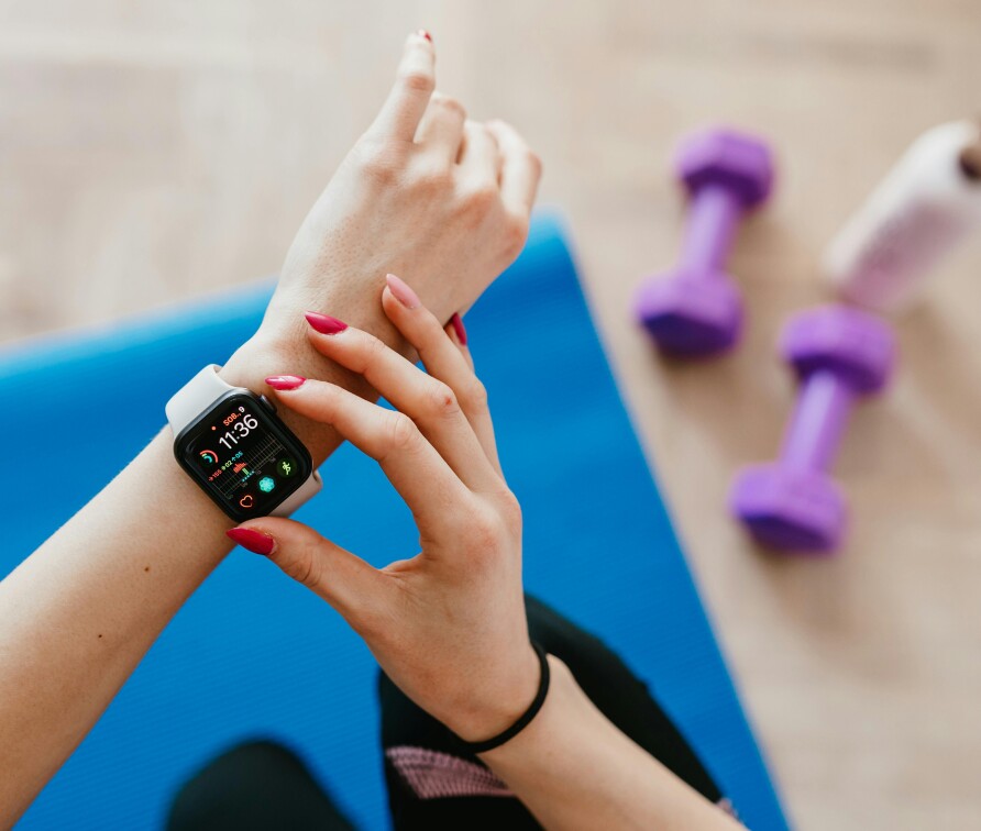 A person checking their smart watch while exercising