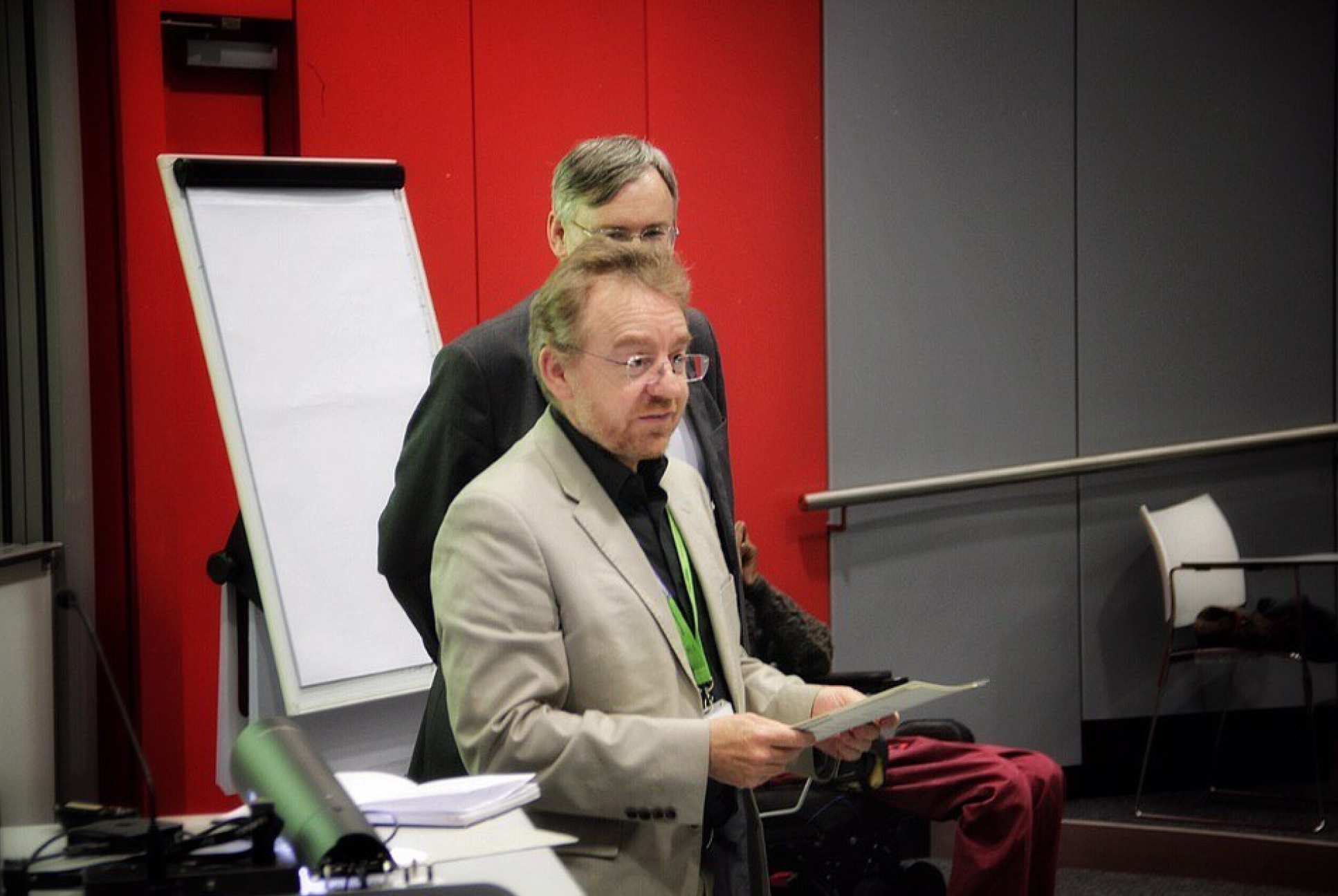 Man talks to audience in lecture theatre