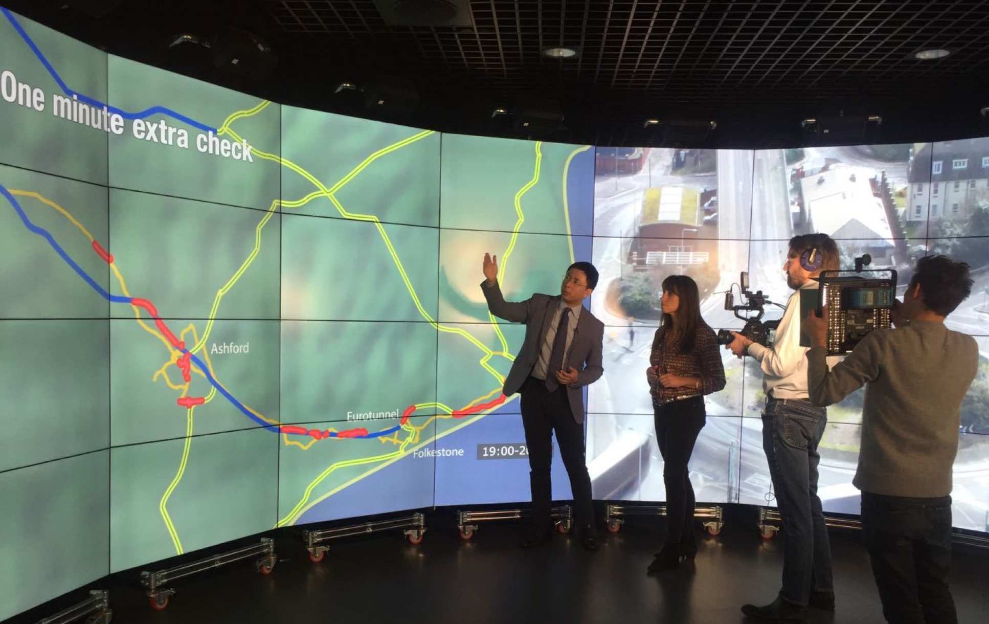 Photo of Dr Han showing BBC journalist through his findings on the Data Observatory while being filmed