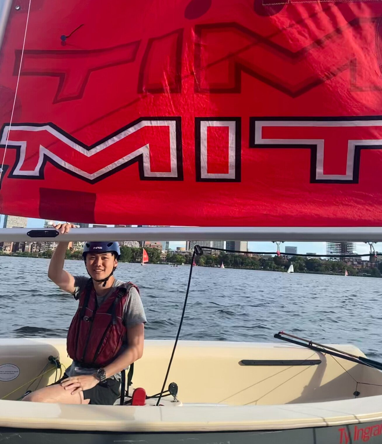 Ethan in an MIT-branded sailing boat