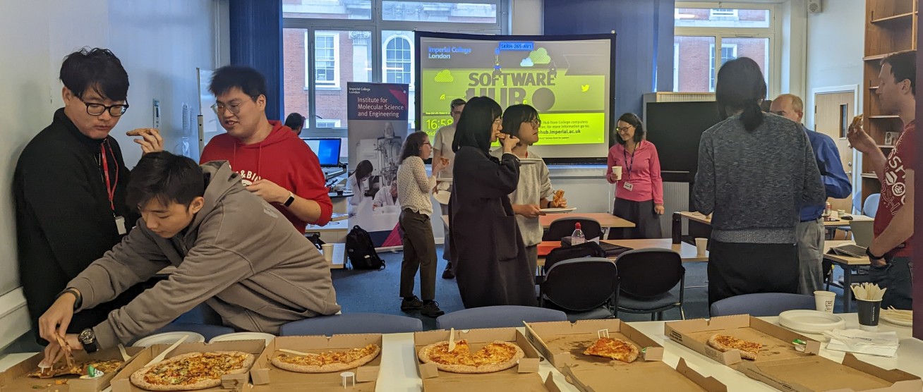 MRes Students, Alumni and Staff enjoying pizza