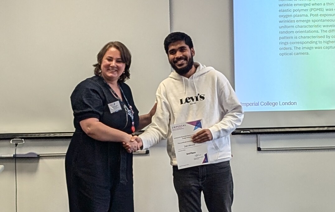 Dr Anna Hankin awarding Zain his prize at IMSE's Research Showcase