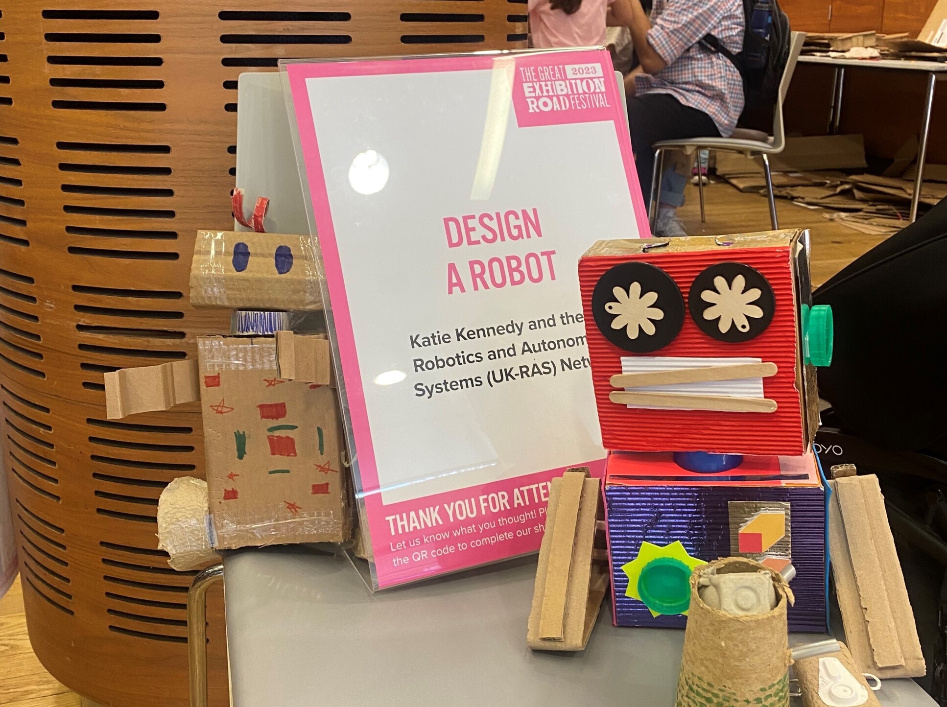 "Design a Robot" sign next to cardboard robots