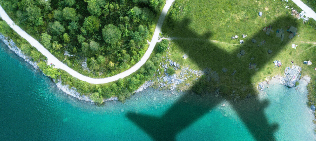 The shadow of a plane going over a S-bended road by the seaside, forBrahmal Vasudevan Institute for Sustainable Aviation Seminar u2013 December