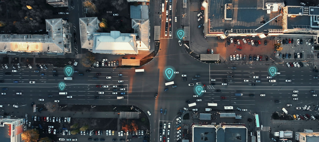 Aerial view of a crossroad with cars marked by symbols typically seen on GPS GPUs.