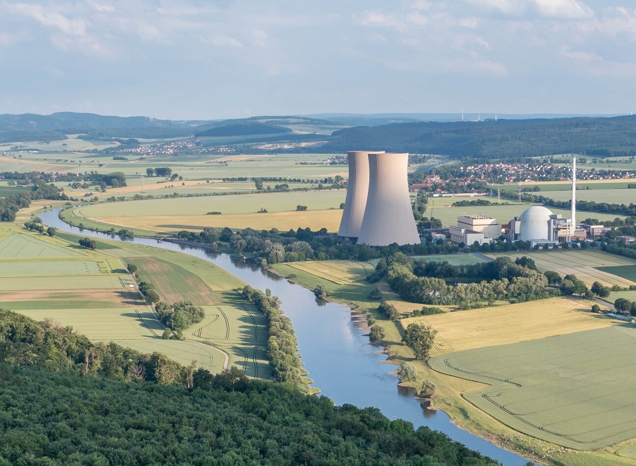 Photo of nuclear power plant, river and fields