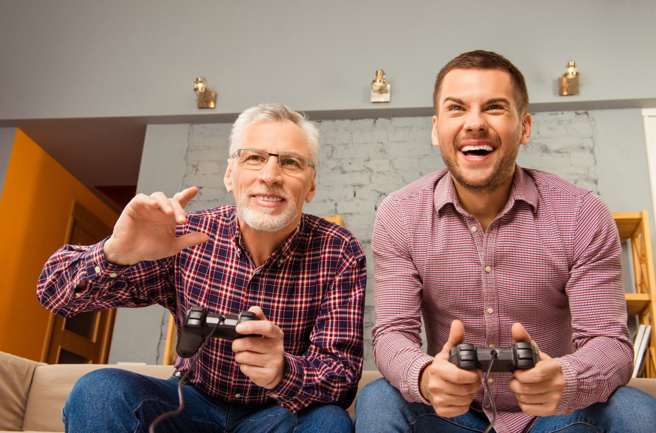 Old and young man playing a video game