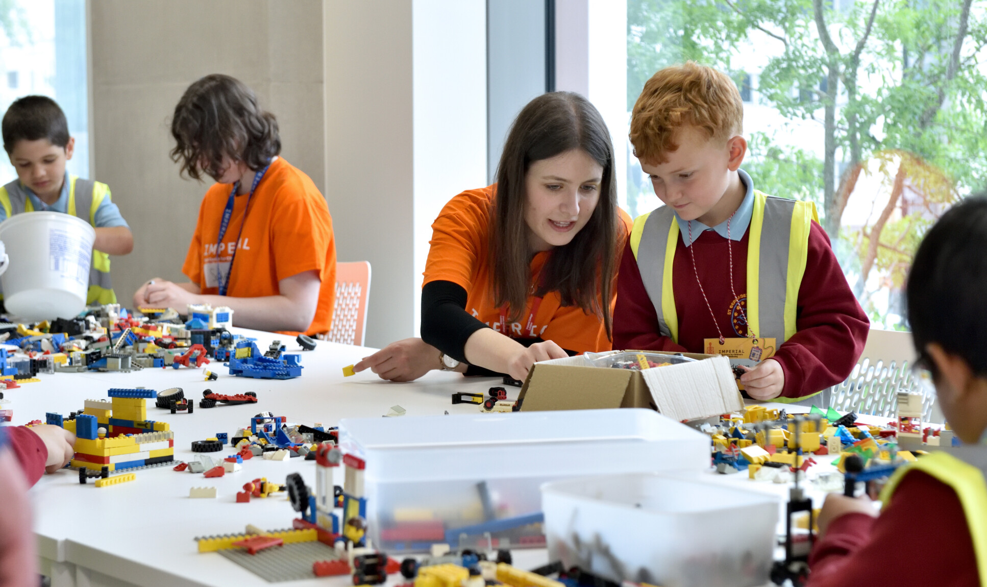 Shira with young person using lego to speak about health