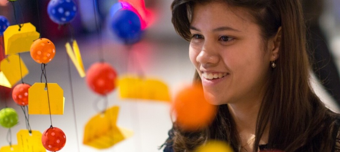 Student with coloured hanging decorations