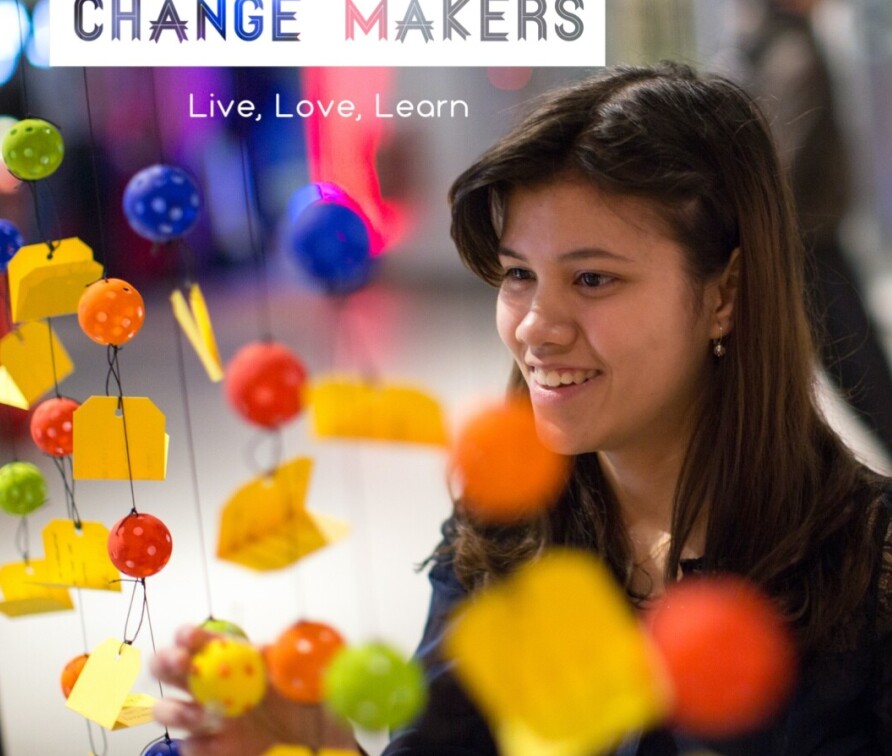 Student with coloured hanging decorations