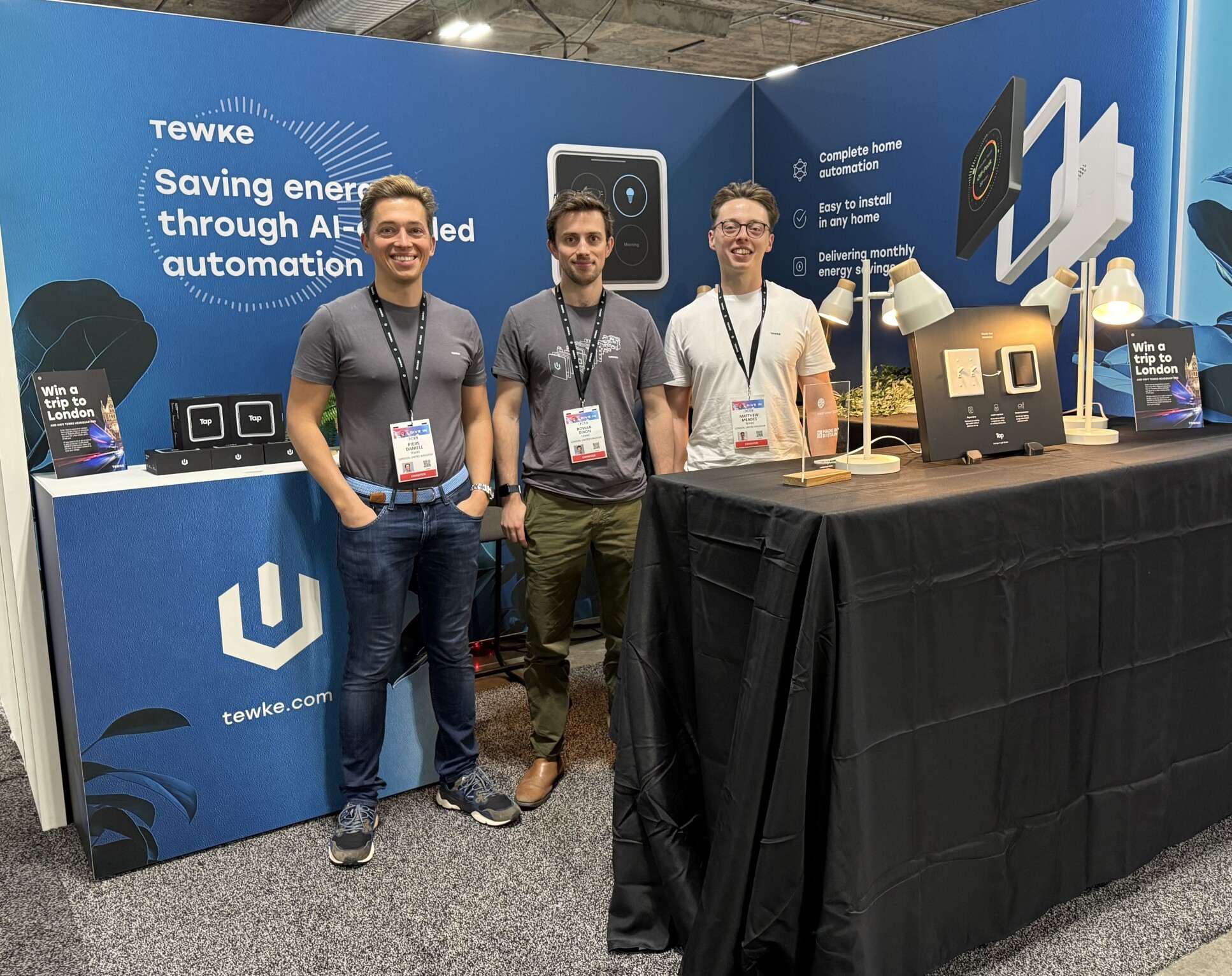 three men at an exhibition booth