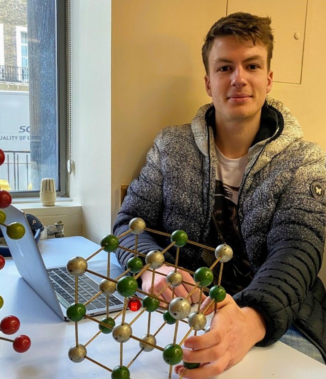 Seán Kavanagh, co-first author and Research Postgraduate with an atomic model of the AgBiS2 rocksalt crystal structure.