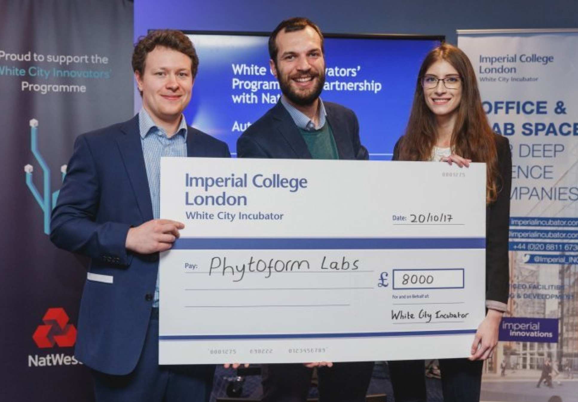 3 members of Phytoform Labs holding a cheque for 8000