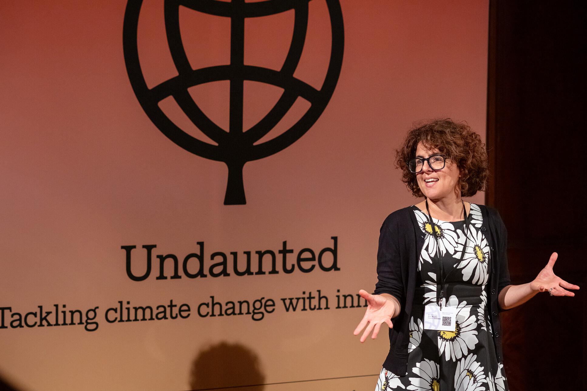 Woman in front of background that says 'Undaunted'