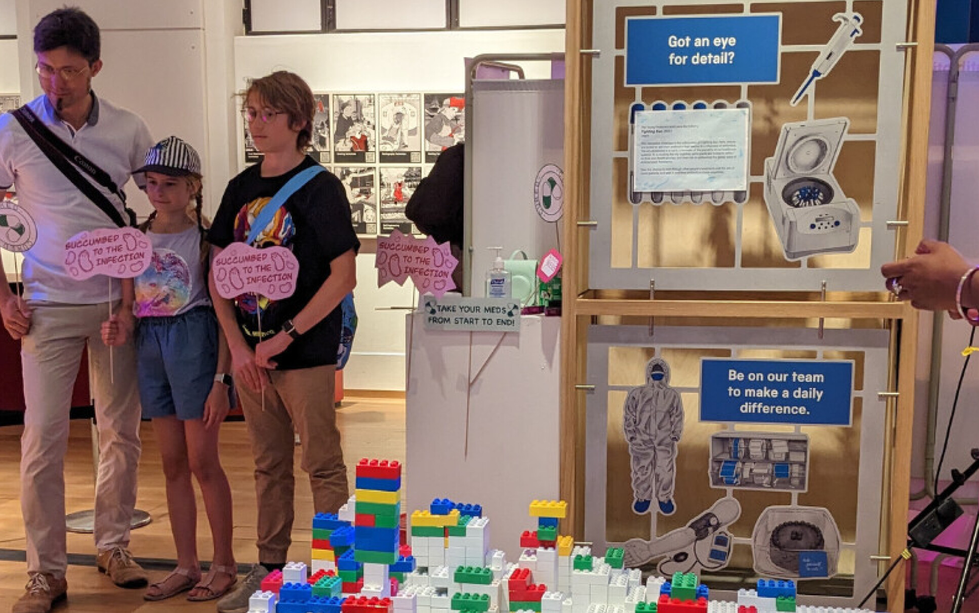 Three people visiting the Fighting Bac exhibit