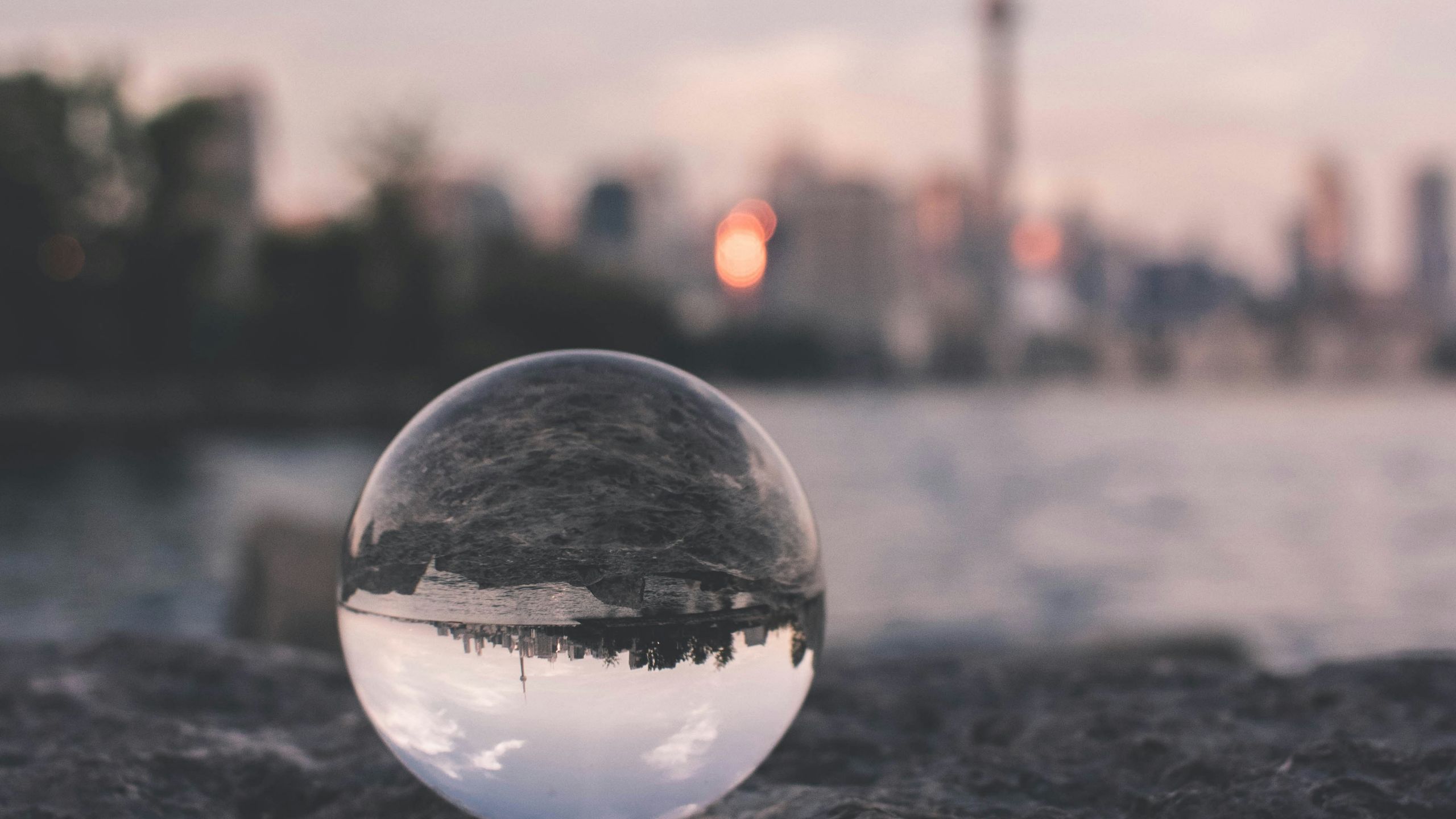 City and river reflected in glass ball