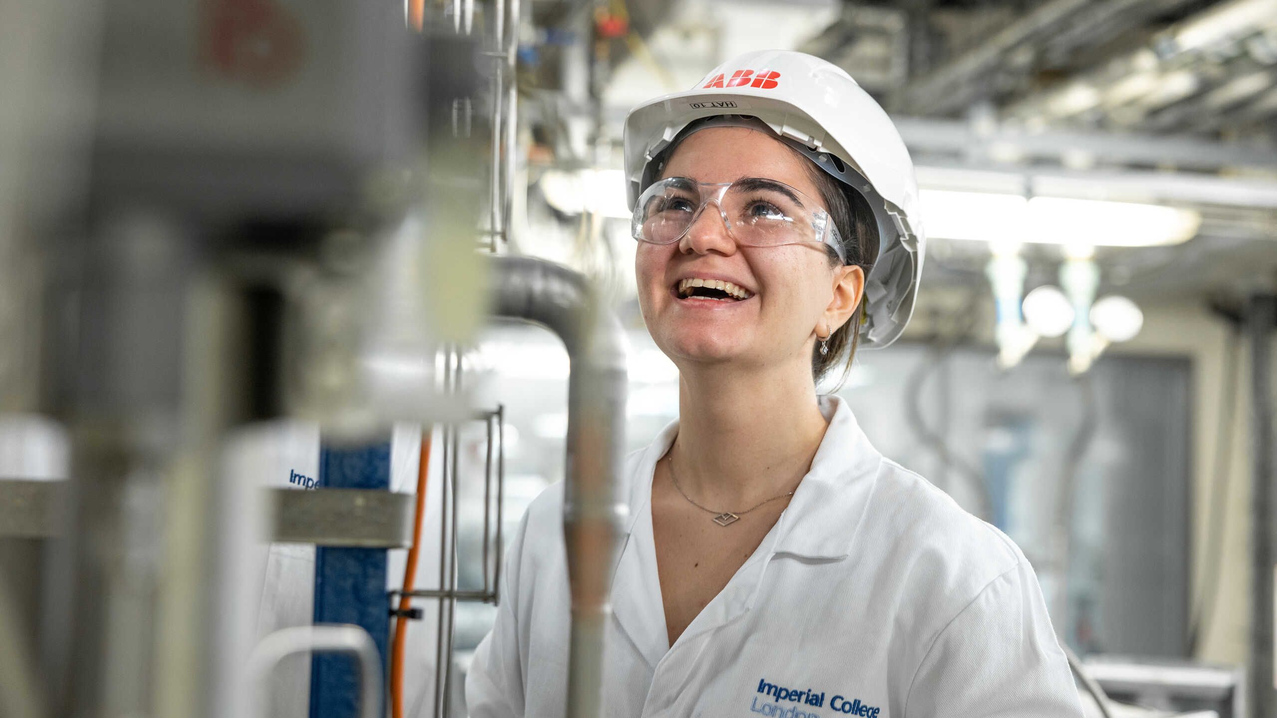 Defne in a Chemical Engineering lab, wearing PPE