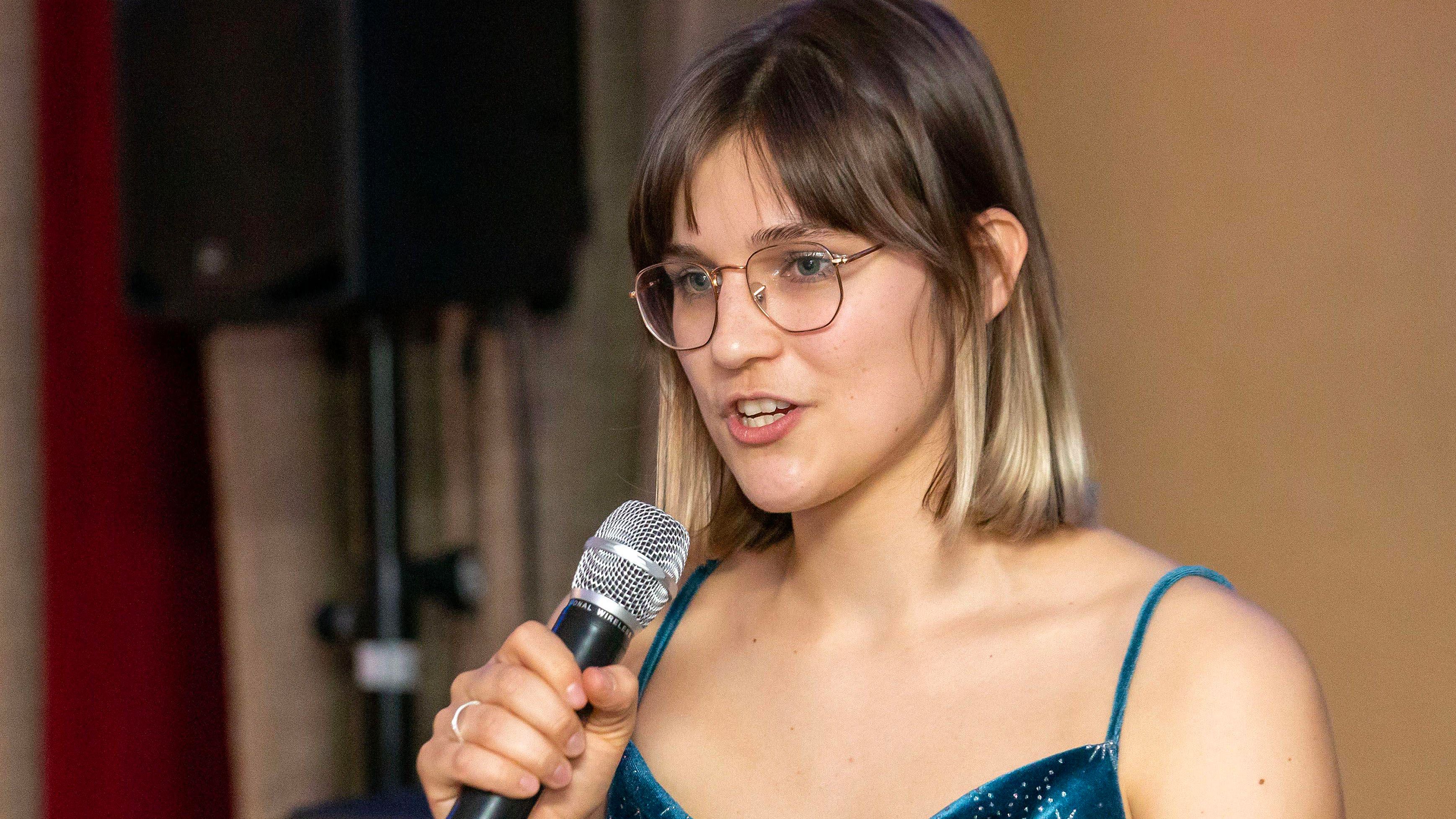 Paulina speaking at a graduation party 