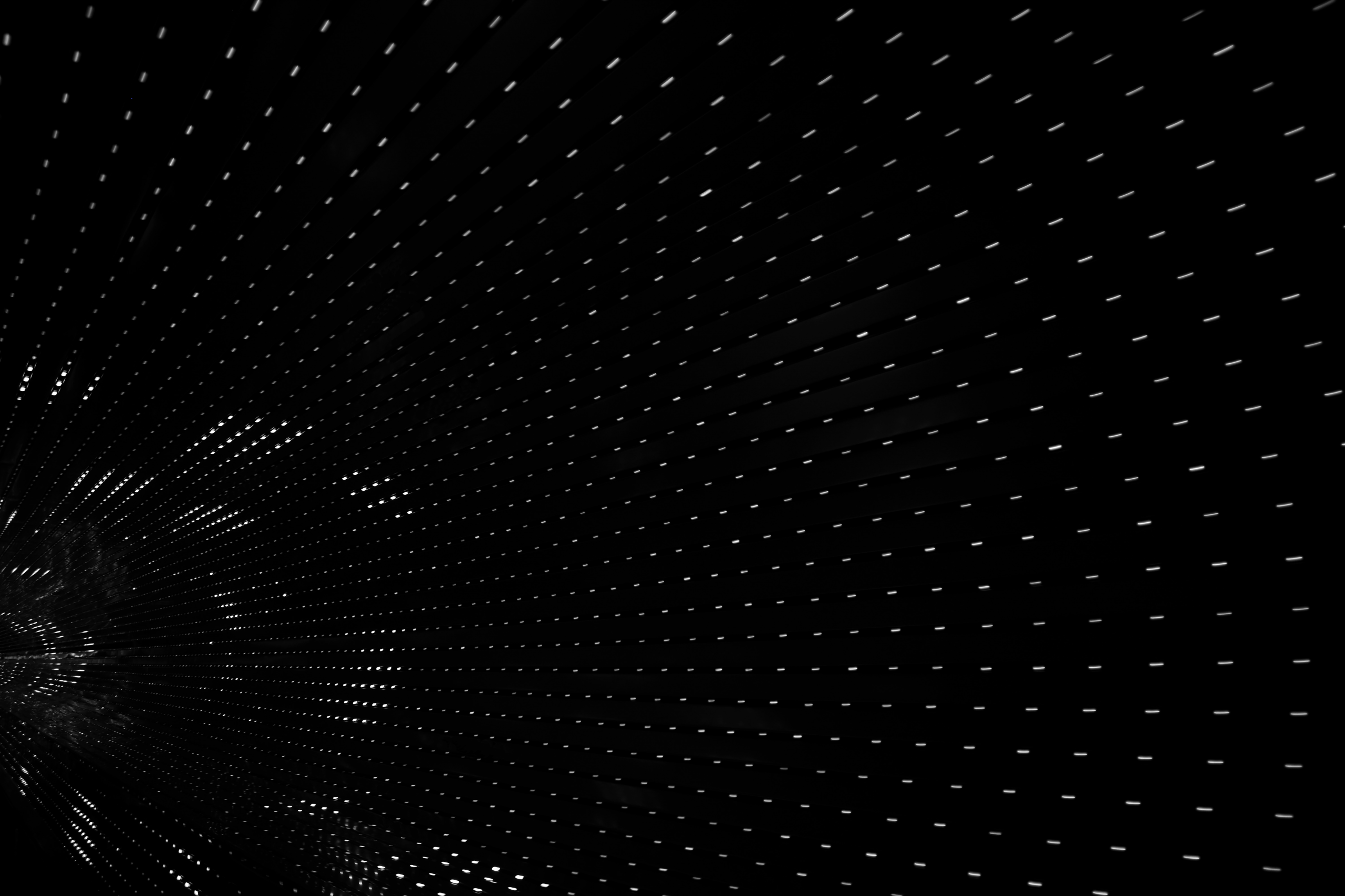 Black tunnel interior with white lights representing data and information travelling.