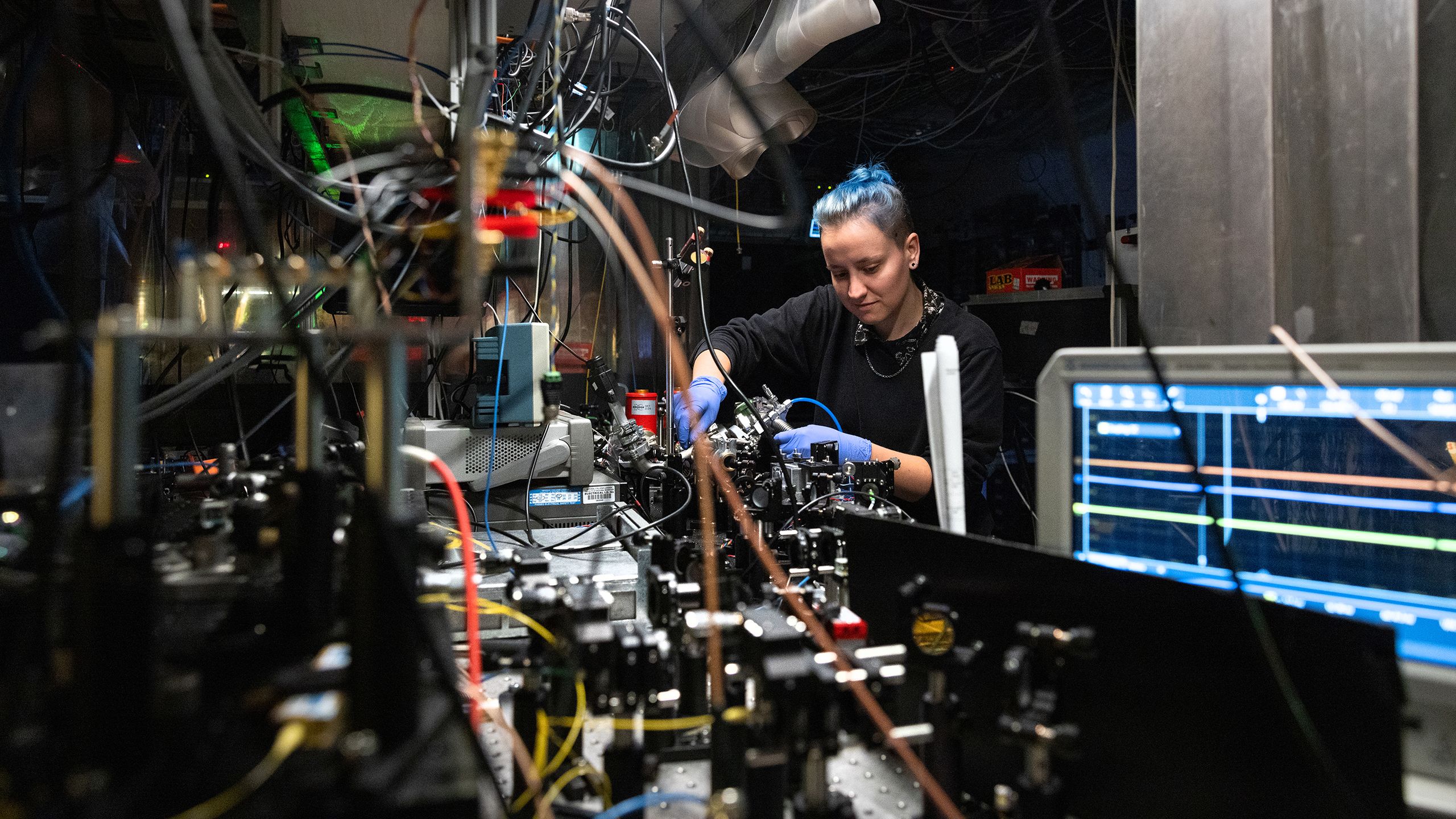 A researcher looks at a tabletop experiment in Imperial's Centre for Cold Matter 