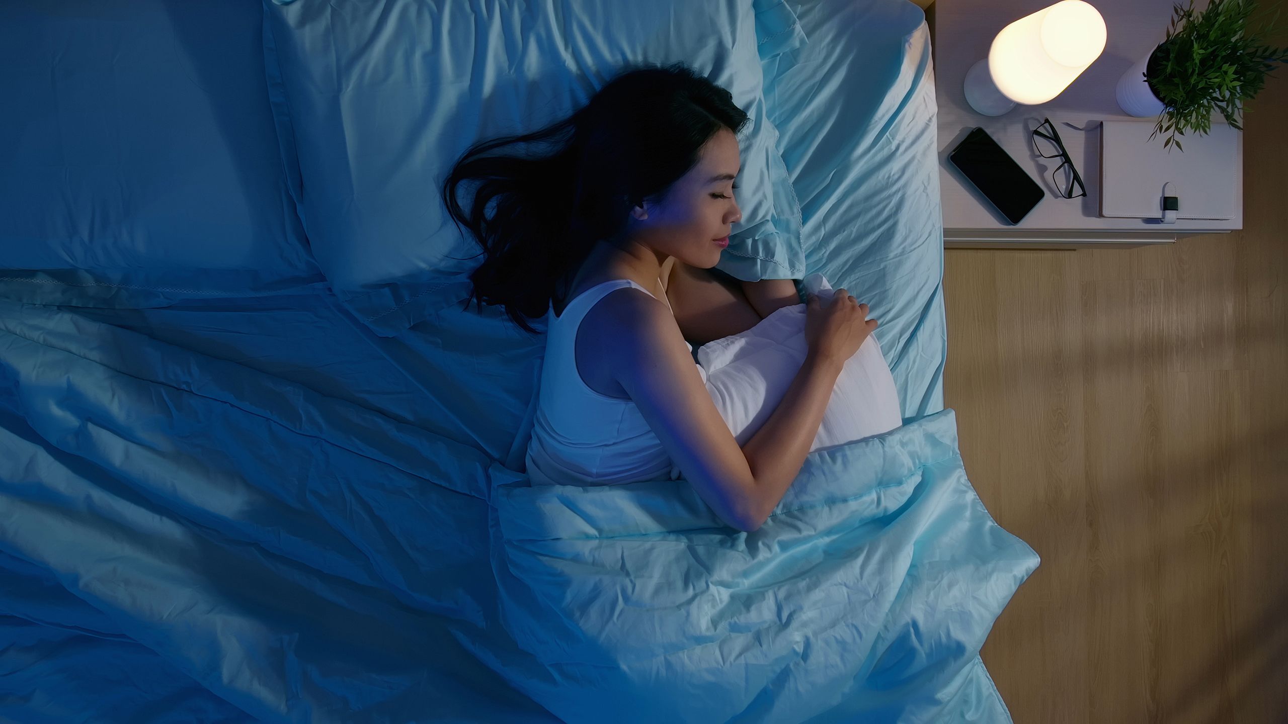 A woman asleep on her side in bed