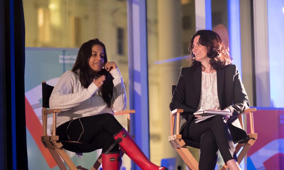 Two woman chatting on stage