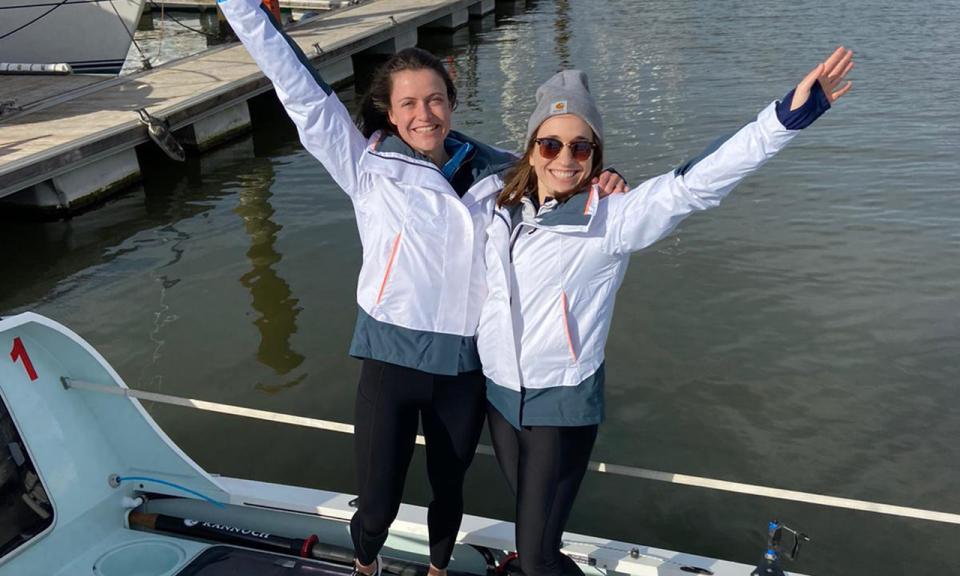 Jessica Oliver (FT MBA 2020) standing on a rowing boat with her rowing partner