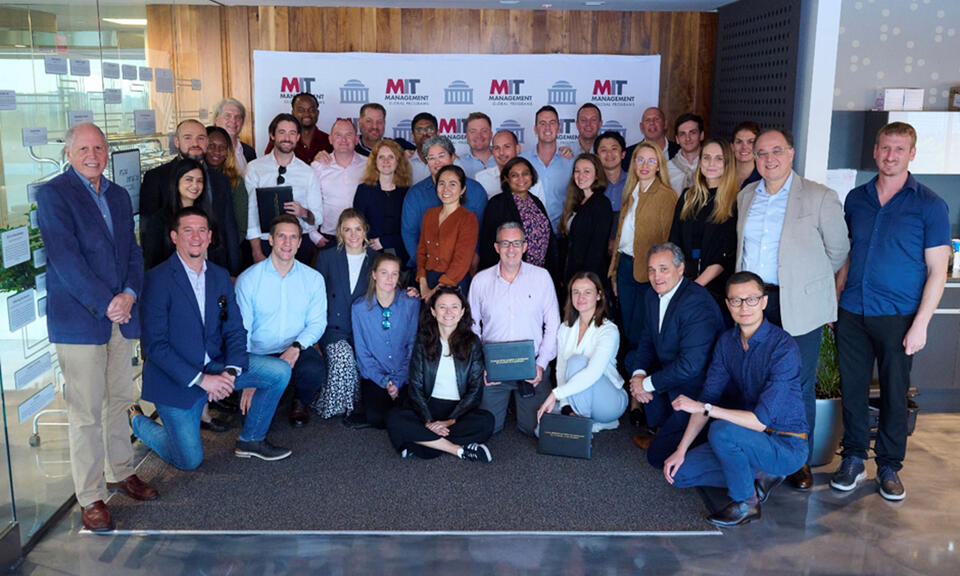 EMBA cohort pose for photo at MIT