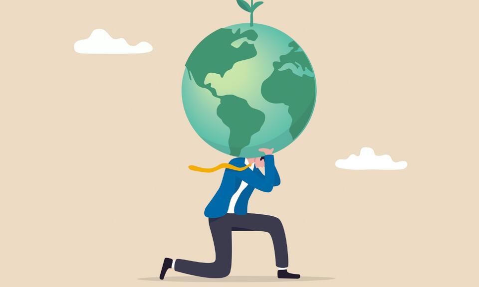 Businessman in atlas pose carrying green globe on his shoulder