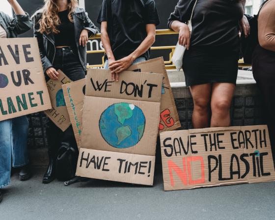 People holding banner signs at a demonstration against climate change