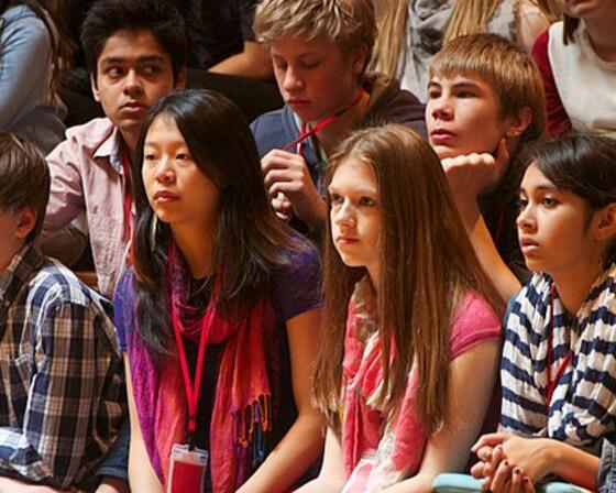 A group of young people of different race and gender sitting together