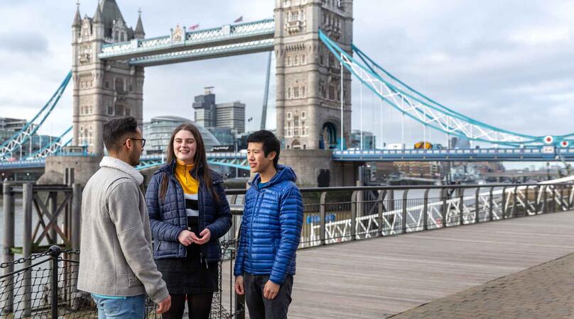 Three students standing in front of Tower Bridge in London