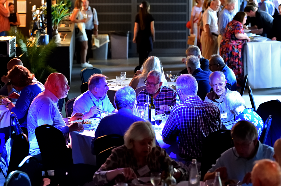 Alumni dining at Metric with blue uplighters illuminating them