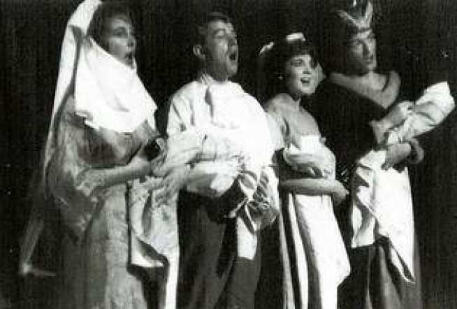Neil (right) as the Duchess carrying the baby and singing a lullaby in the Westminster Medical School production of 'Alec in Blunderland' in 1962
