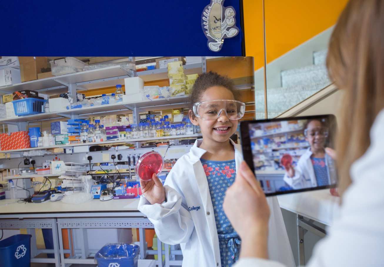 Child in lab coat and goggles at Imperial Festival